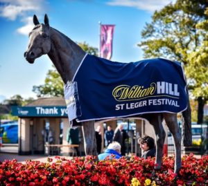 Who is the leading trainer in the history of the St. Leger?  